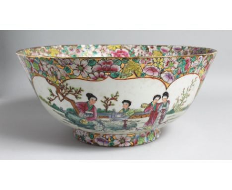 A LARGE CHINESE CANTON PORCELAIN PUNCH BOWL, the interior painted with female figures in a garden, the rim with a band of vib