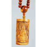 A TIBETAN STRING OF CARVED YAK BONE PRAYER BEADS with a large carved amulet depicting Guanyin,