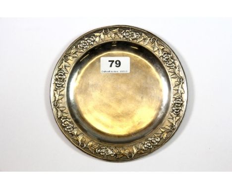 An .800 silver wine bottle coaster with grapevine design to the rim