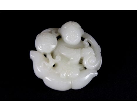 A fine carved white jade figure of a child with a lotus pod and root (5cm x 5cm x 1.5cm) Est. £250-300