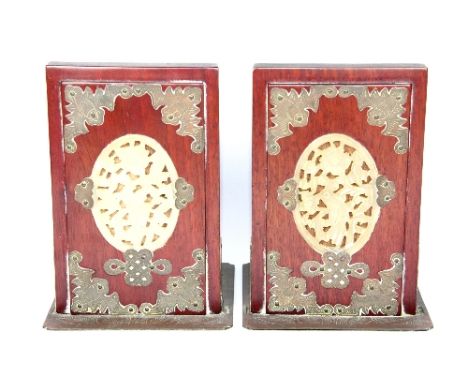 A pair of Chinese 1930s red hardwood and brass bookends inset with carved jade panels H:16cm