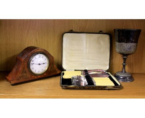 A silver plated goblet, mantle clock and fish set