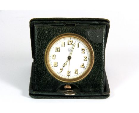 A vintage leather cased travelling clock 11cm x 11cm