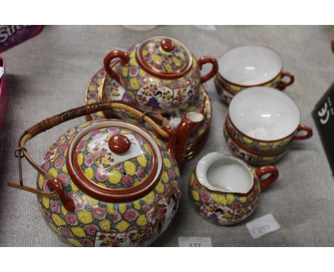 A Japanese tea service with Geisha girl at base of cups 
