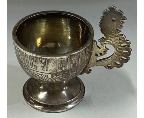 A 19th Century Russian silver vodka cup with pierced handle. Marked to base. 1884. Approx. 39 grams. Est. £100 - £150.