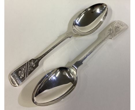 A good pair of silver fiddle pattern dessert spoons with bright-cut decoration. Sheffield. By SH. Approx. 140 grams. Est. £60