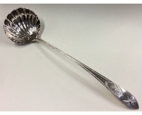 A good bright-cut silver soup ladle with fluted bowl to crested terminal in the Georgian style. Sheffield. By HA. Approx. 200