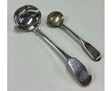 EXETER: A silver fiddle pattern cream ladle together with a salt spoon. Approx. 26 grams. Est. £20 - £30.