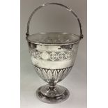 A pierced silver swing handled basket with glass liner in the Georgian style.