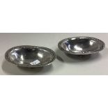 GEORG JENSEN: A pair of chased silver dishes on feet.
