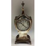A large silver clock on feet.