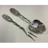 A Judaica silver leaf vine spoon and fork with chased menorah decoration.