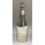 A silver pepper in the form of a champagne bottle.