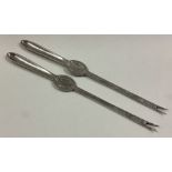 A pair of silver lobster picks.