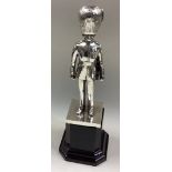 A cast silver figure of a Grenadier Guard.