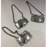 A suite of three Victorian silver wine labels.