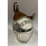 A fine Georgian silver cream jug with bright-cut decoration.
