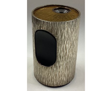 A silver and enamelled lighter with bark finish. London 1972. By Gerald Benney. Approx. 332 grams. Est. £1000 - £1500.