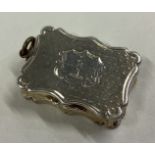 A small hinged top silver vinaigrette with gilt interior.