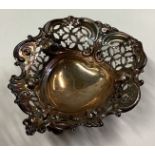 A small heart-shaped silver pin dish.