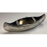 A silver model of a canoe.