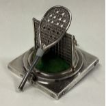 An unusual novelty silver pin cushion in the form of a tennis racket on rectangular base.