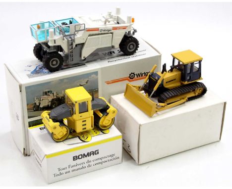 A collection of three various boxed construction and earth moving vehicles to include an NZG No. 446 Wirtgen WR2500 soil stab