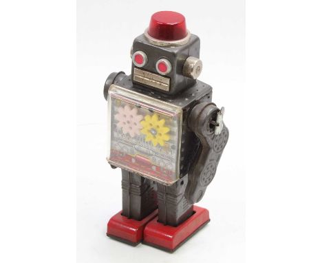 An SH Toys of Japan tinplate and clockwork operated gear robot comprising grey and silver body with red feet, single fixed ke