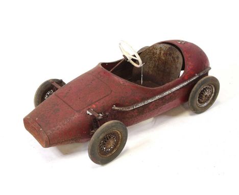 A Triang Childs Ferrari Grand Prix Pedal Car, red body, with white steering wheels, model is heavily rusted and requires rest