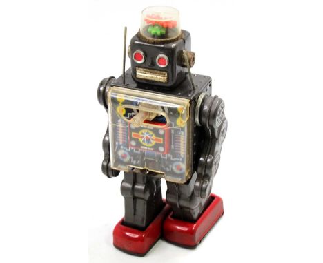 An SH Toys of Japan tin plate and battery operated Fighting Robot, comprising of metallic grey body with red feet and open vi