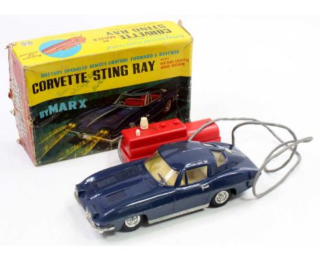 A Marx Toys plastic and battery operated model of a Corvette Stingray finished in dark blue with cream interior and red hands