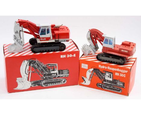 An NZG boxed O&amp;K mining shovel 1/50 scale diecast group to include an RH30-E, together with an RH30-C hydraulic excavator