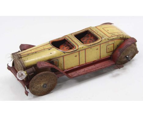 German tinplate and clockwork 2 seated open top tourer, comprising cream body with red running board, battery feature for lig