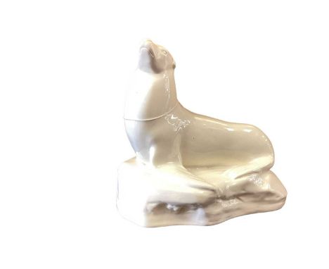 A John Skeaping for Wedgwood cream glazed model of a Seal, circa 1920s, the seal raised on front flippers and set on a stylis