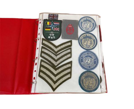 One album of cloth British Army badges, divisional and formation patches and insignia.