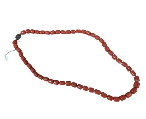 Old Chinese coral necklace with barrel shaped polished beads and oval silver gilt clasp with wire work flower decoration, 64.
