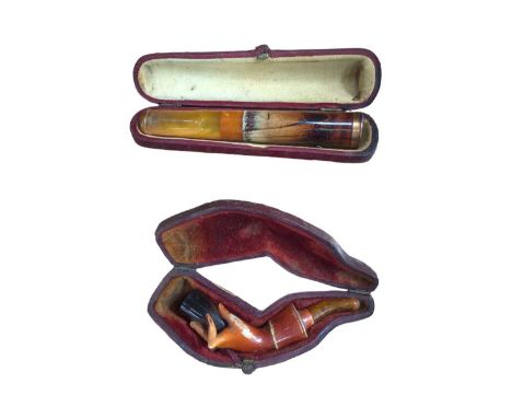 Cased cheroot holder with amber mouthpiece, and a cased meerschaum pipe in the form of a hand (2)