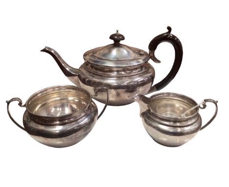 1930s silver three piece tea set comprising of a teapot with a bakelite handle and finial, milk jug and two handled sugar bow