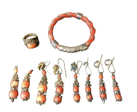 Old Chinese coral carved rope twist bangle with white metal mounts, 8cm diameter, a similar coral ring and four pairs of cora