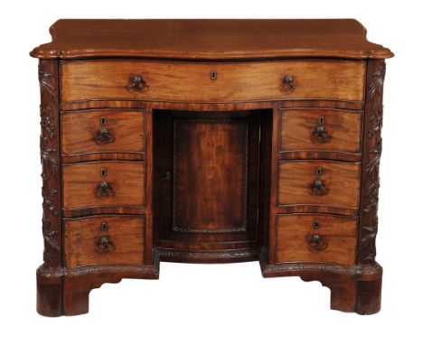 A George III mahogany serpentine kneehole desk, circa 1760  A George III mahogany serpentine kneehole desk,   circa 1760, the