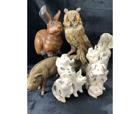 Collection of decorative animal and bird figurines to include ceramic pigs, a begging dog, carved rabbit and a ceramic owl