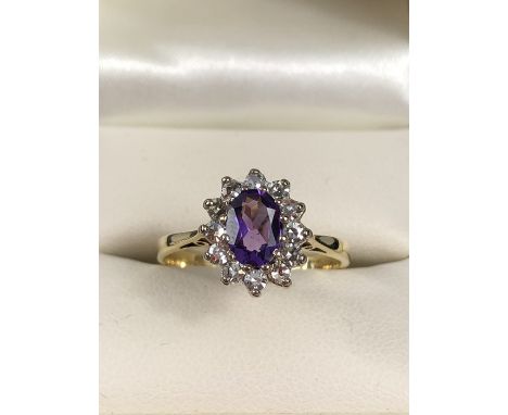 Maker Steele and Dolphin 18ct Amethyst and diamond cluster ring. The Amethyst measures approx: 7.35mm x 5.12mm across. Size a