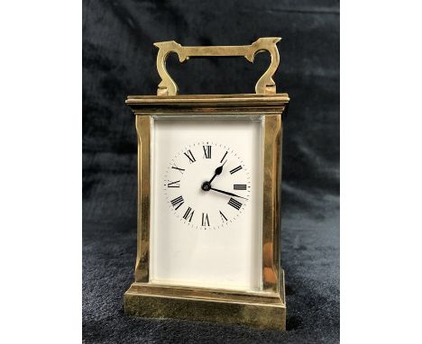 A circa 1900 brass carriage clock, the rectangular face with circular chapter ring set with Roman numerals, back stamped WJH,