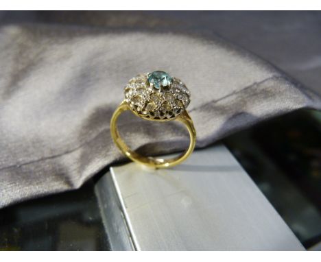 18ct Gold zircon Ring, Central natural blue zircon surrounded by 20 small clear Zircons set in two circles of white gold, mea