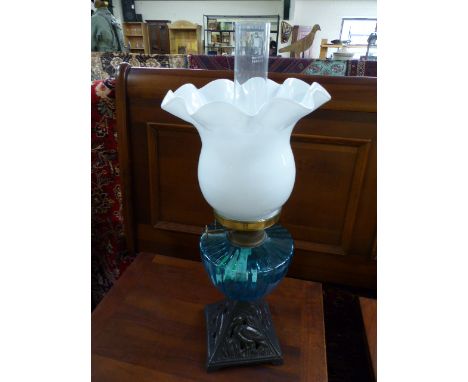 China foliate decorated oil lamp on brass frame with amber glass shade and twin burner