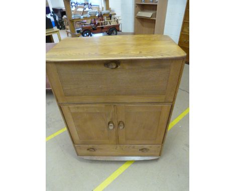 An Ercol light elm drinks cabinet with drop front and cupboard with single drawer