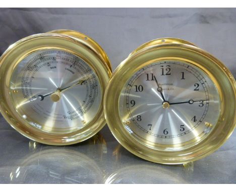 Portfolio Tiffany & Co Brass bulkheads ship clock along with a matching brass cased barometer.