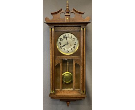 VINTAGE OAK PENDULUM WALL CLOCK having silvered dial set with Roman numerals behind a bevelled edge glazed door, 90cms approx