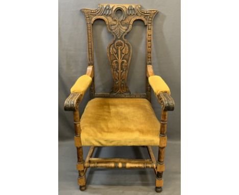 VINTAGE CARVED OAK ARMCHAIR having decorative crest rail and splatback, knurled end arms on turned and block supports (origin