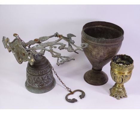 WEATHERED BRASS FIGURAL GUARDIAN ANGEL WALL MOUNTED DOORBELL, Regency brass finial and a chased Indian brass goblet